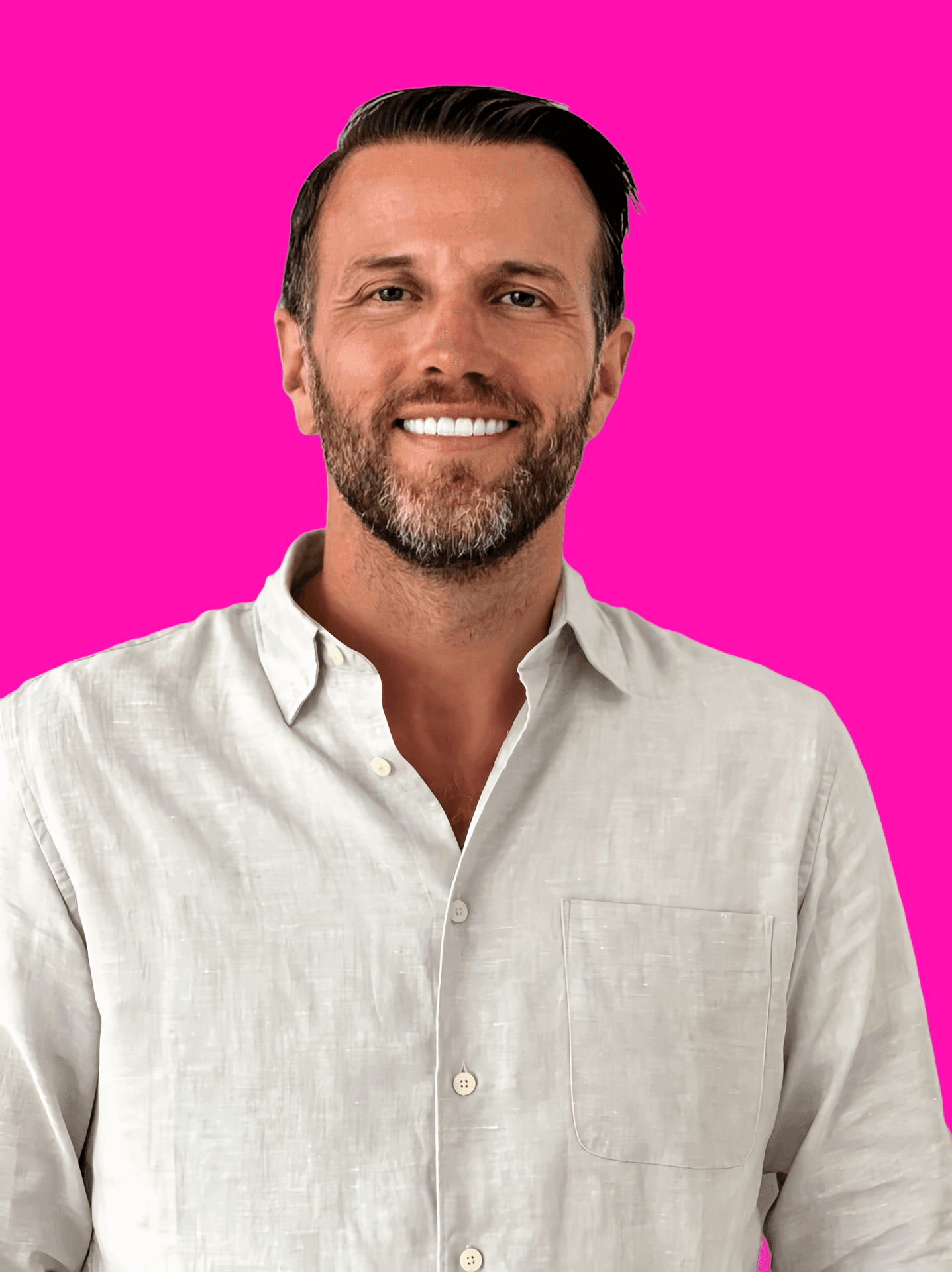 Smiling man in a light shirt with a pink background.