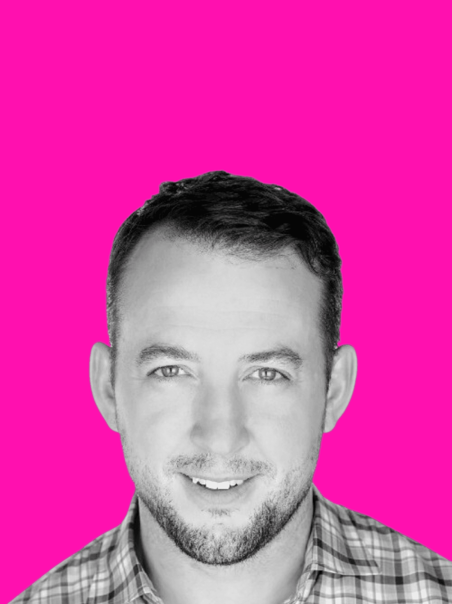 Person wearing a checkered shirt against a bright pink background.